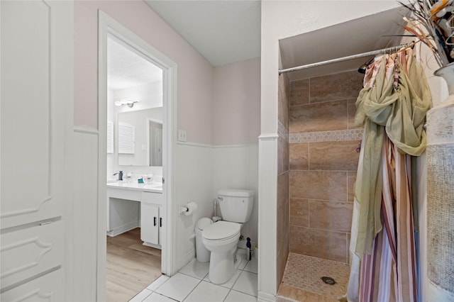 bathroom with tile patterned flooring, vanity, a textured ceiling, a shower with curtain, and toilet