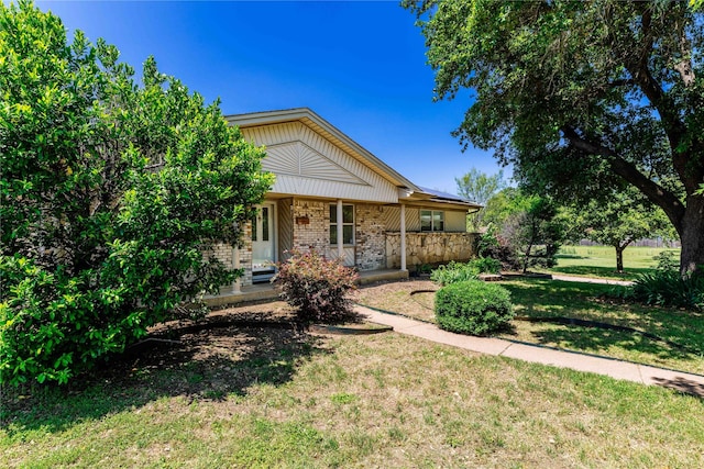 view of front of home with a porch and a front lawn