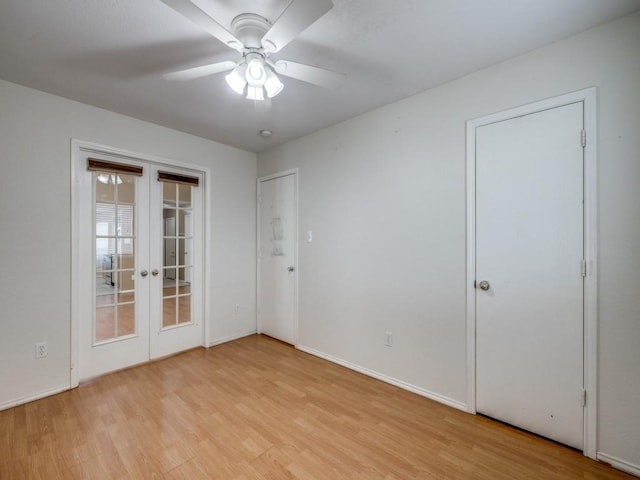 spare room with light wood-type flooring, ceiling fan, and french doors