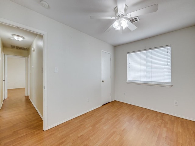 spare room featuring ceiling fan and light wood-type flooring