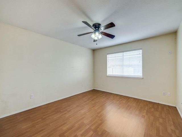 spare room with ceiling fan and light wood-type flooring