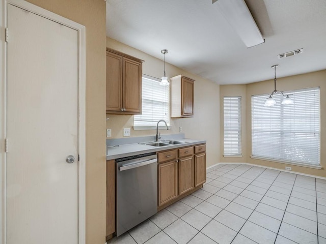 kitchen with sink, light tile patterned floors, dishwasher, and hanging light fixtures