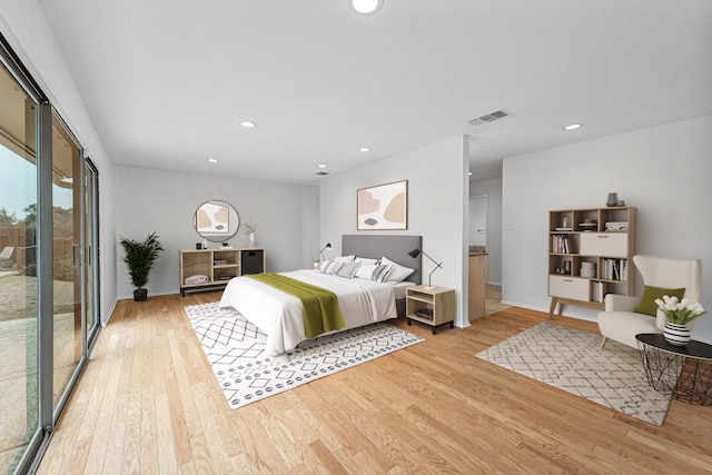 bedroom with light hardwood / wood-style floors and access to outside