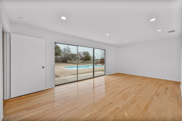 spare room featuring light hardwood / wood-style floors