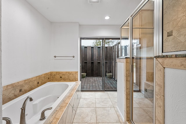 bathroom featuring tile patterned floors and independent shower and bath