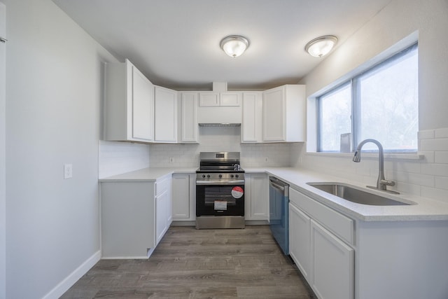 kitchen featuring sink, backsplash, white cabinetry, and stainless steel appliances