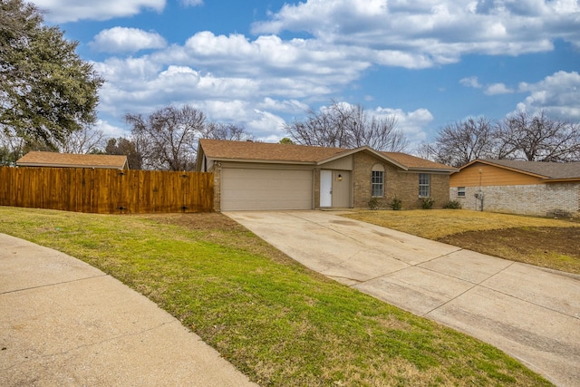 ranch-style home featuring a garage and a front lawn