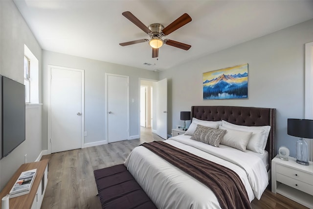 bedroom with ceiling fan and light hardwood / wood-style floors