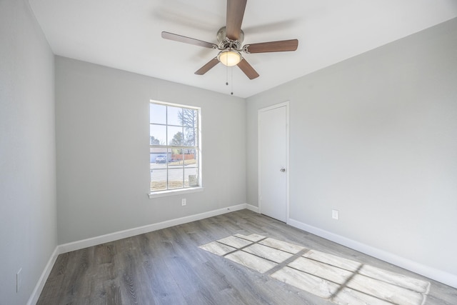 unfurnished room with ceiling fan and hardwood / wood-style flooring