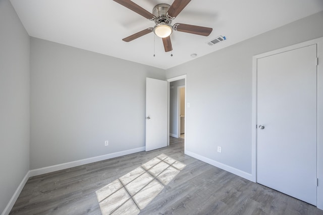 unfurnished bedroom with hardwood / wood-style flooring and ceiling fan