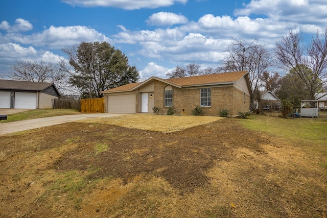 ranch-style house featuring a garage and a front yard