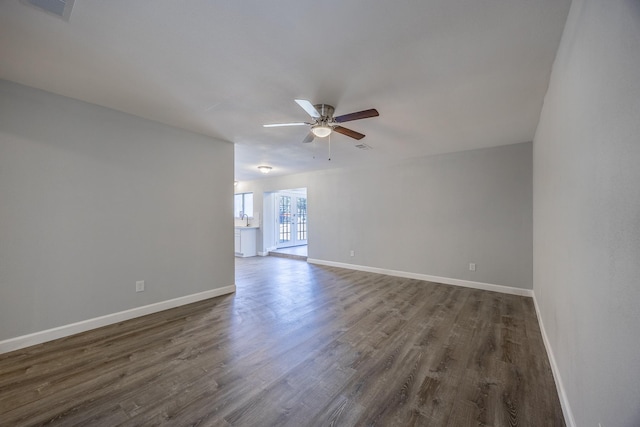 empty room featuring ceiling fan and dark hardwood / wood-style floors