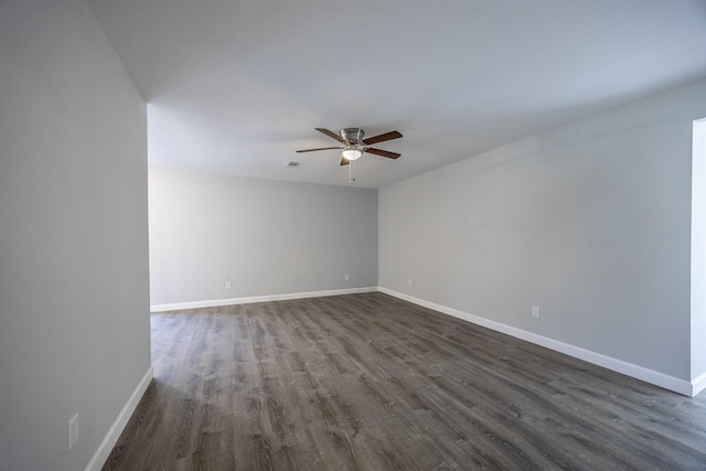 empty room featuring ceiling fan and dark hardwood / wood-style flooring