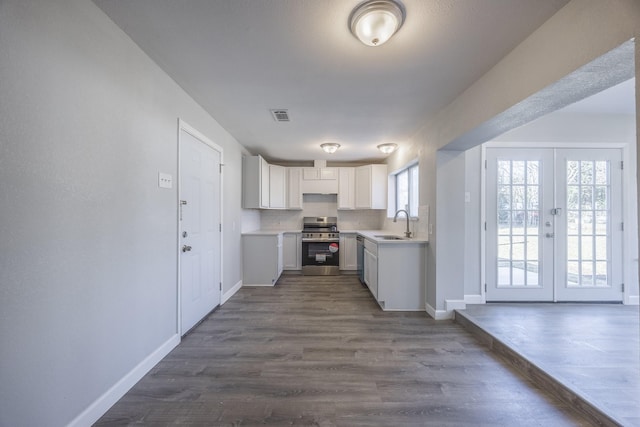 kitchen featuring white cabinets, stainless steel appliances, french doors, sink, and dark hardwood / wood-style floors