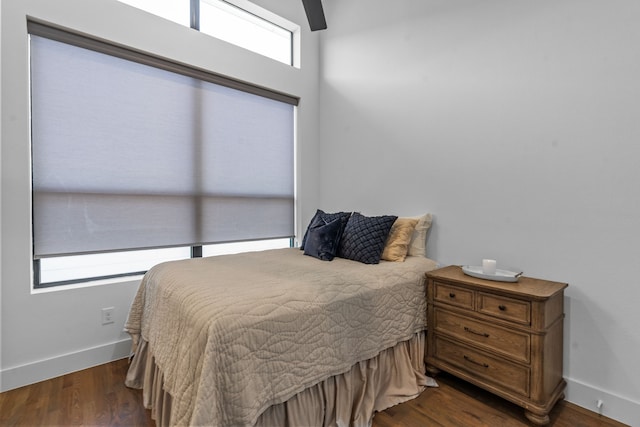 bedroom with ceiling fan and dark wood-type flooring