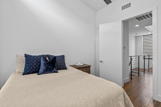 bedroom with dark hardwood / wood-style flooring and lofted ceiling