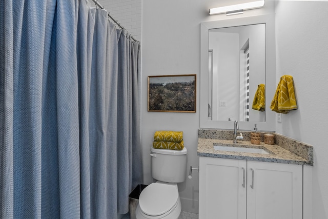 bathroom featuring vanity, toilet, and a shower with curtain