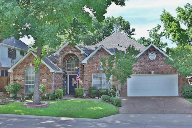 front of property featuring a garage and a front lawn