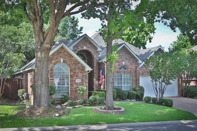 front facade featuring a garage and a front lawn