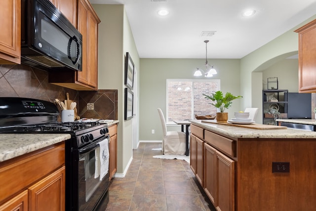 kitchen with black appliances, tasteful backsplash, a chandelier, dark tile patterned flooring, and pendant lighting