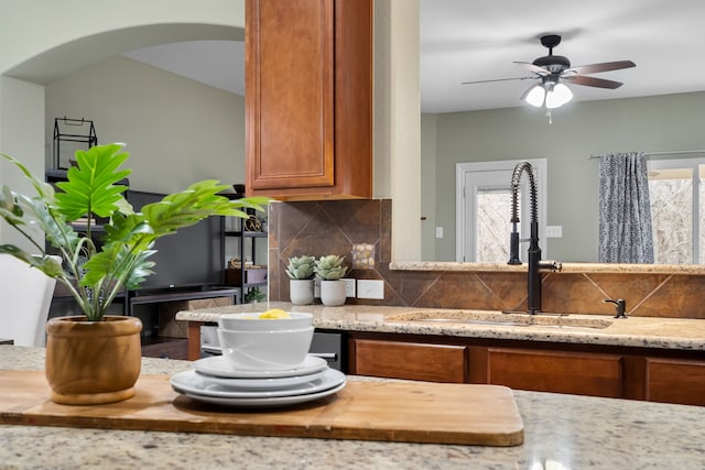 kitchen featuring sink, tasteful backsplash, a wealth of natural light, and ceiling fan