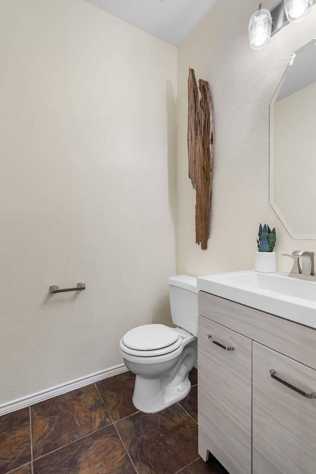 bathroom with toilet and vanity