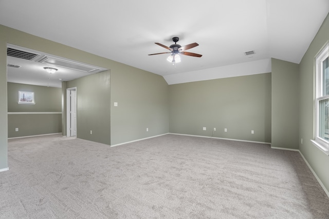 empty room featuring ceiling fan, light colored carpet, and lofted ceiling