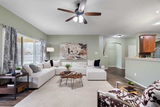 living room featuring ceiling fan and light hardwood / wood-style flooring