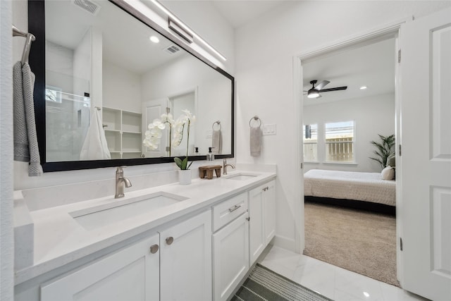 bathroom with double vanity, visible vents, and a sink