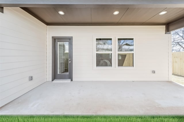 view of exterior entry with a patio