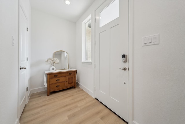 foyer with light wood-type flooring and baseboards