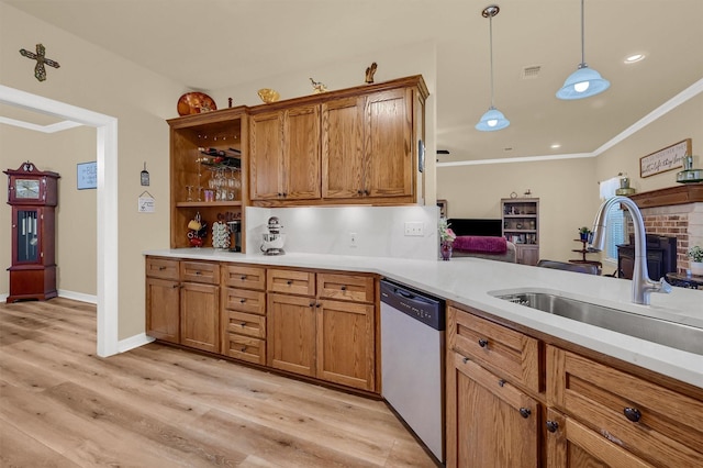 kitchen featuring dishwasher, hanging light fixtures, sink, light wood-type flooring, and ornamental molding