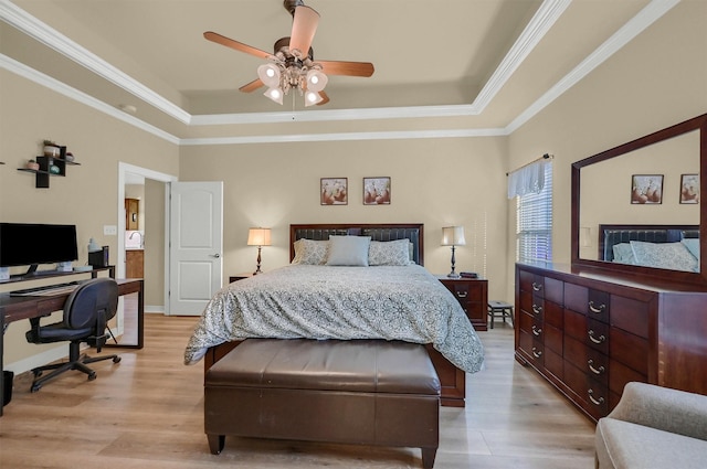 bedroom featuring light wood-type flooring, ceiling fan, a raised ceiling, and ornamental molding