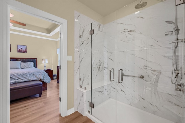 bathroom with wood-type flooring, walk in shower, and ornamental molding