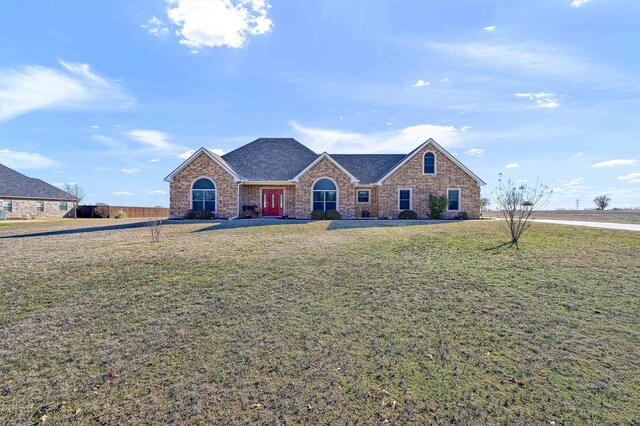 ranch-style home featuring a garage and a front yard