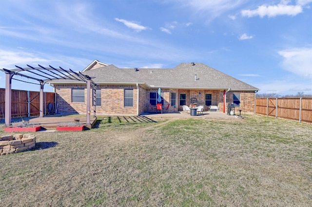 rear view of house featuring a pergola, an outdoor fire pit, a lawn, and a patio