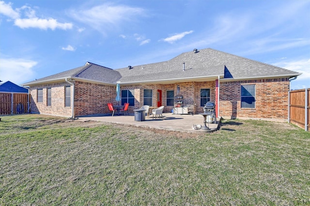 back of house with a patio and a yard