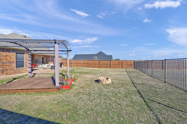 view of yard featuring a deck, a pergola, and a fire pit