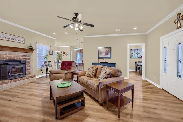 living room featuring ceiling fan, light hardwood / wood-style flooring, and crown molding