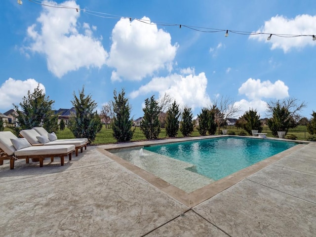 outdoor pool featuring a patio area and fence