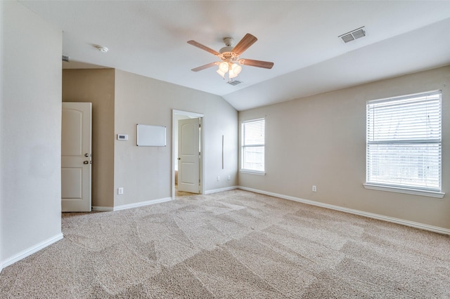 unfurnished bedroom with ceiling fan, lofted ceiling, and light colored carpet