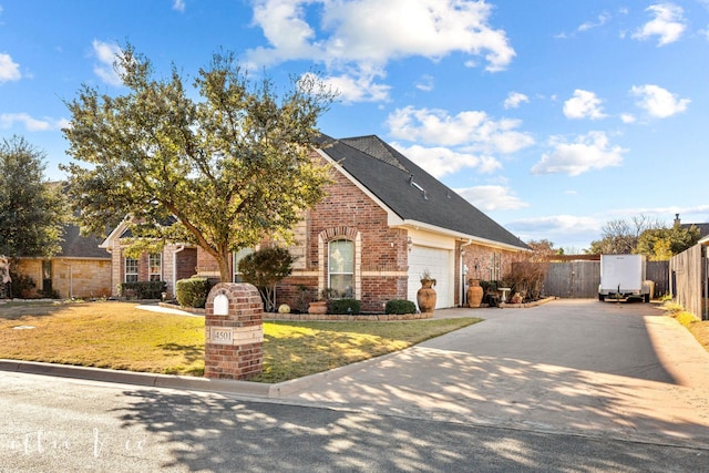 view of front facade with a front yard and a garage