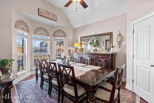 dining area with a healthy amount of sunlight, dark wood-type flooring, and lofted ceiling