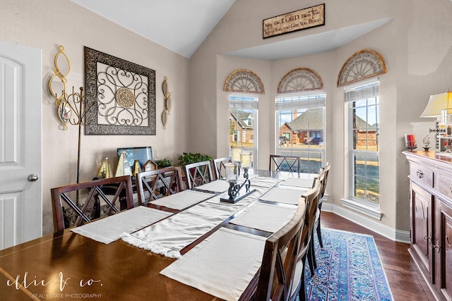 dining room with dark hardwood / wood-style flooring and vaulted ceiling