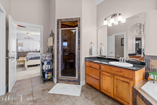 bathroom with tile patterned floors, vanity, and independent shower and bath