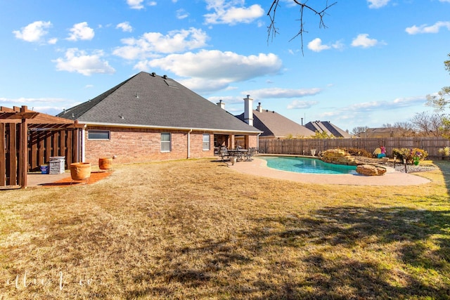 view of swimming pool featuring a patio area and a yard