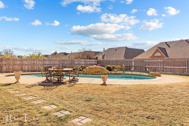 view of pool with a lawn