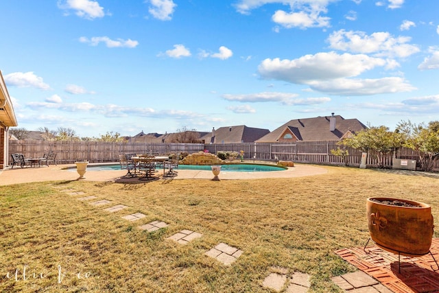 view of yard with a patio area and a fenced in pool