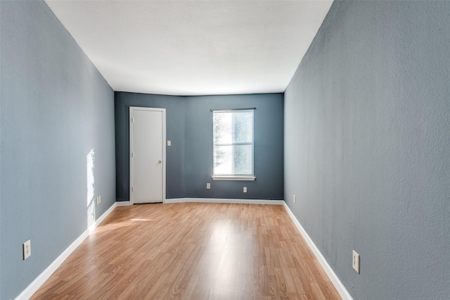 empty room with light hardwood / wood-style flooring