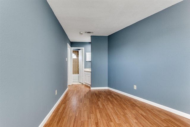 unfurnished room with light wood-type flooring